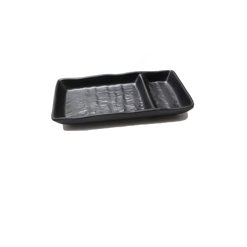 a black rectangular sushi plate with a divider