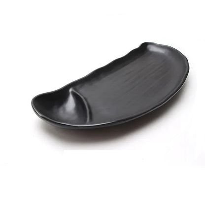 a black sushi tray with a curved edge