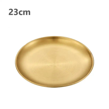 a gold stainless steel round plate with a white background 23 cm