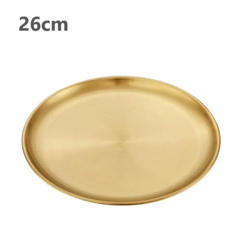 a gold stainless steel round plate with a white background 26 cm