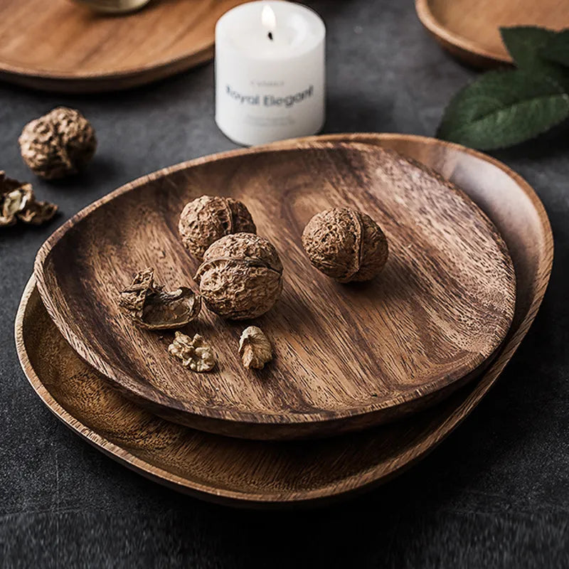 a group of wooden plates with nuts on them