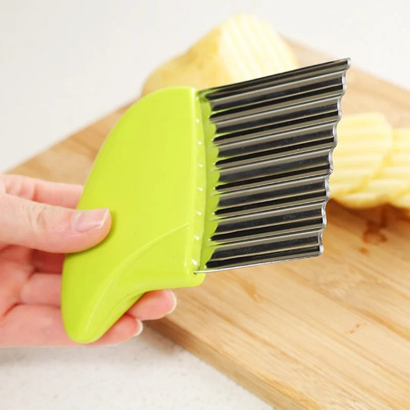 a hand holding a green crinkle potato cutter