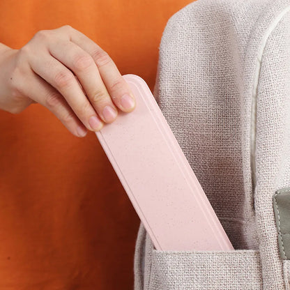 a hand holding a pink travel case in a backpack pocket