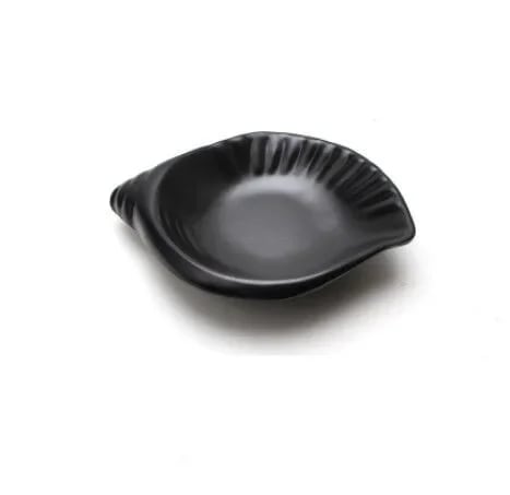 a large black shell shaped plate