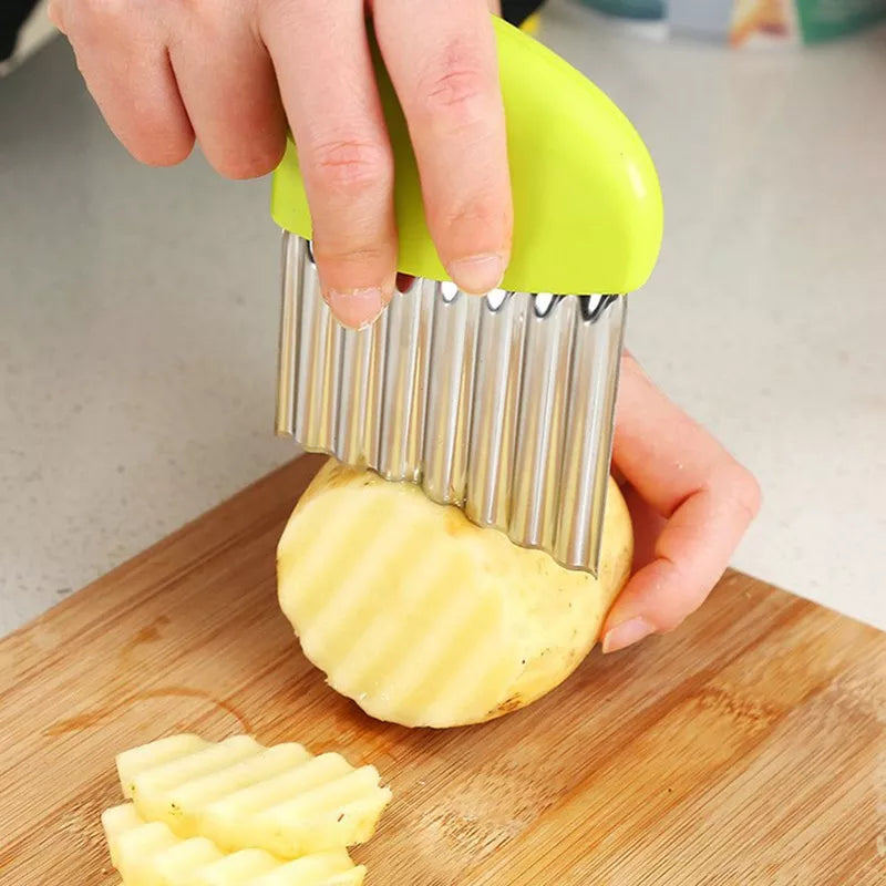 person cutting potato with a crinkle cutter on a cutting board