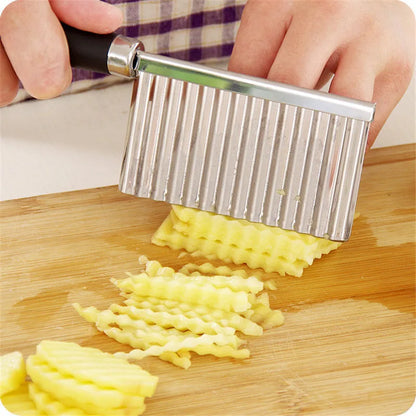 person cutting potatoes on a cutting board with a crinkle potato cutter with handle