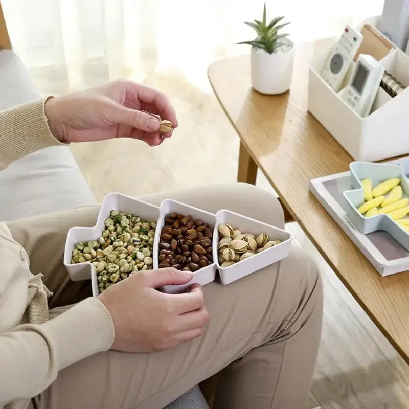 a person holding a christmas tree tray with nuts