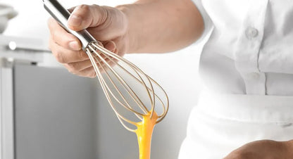 person holding a whisk