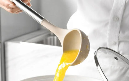 person pouring egg into a bowl with a scoop