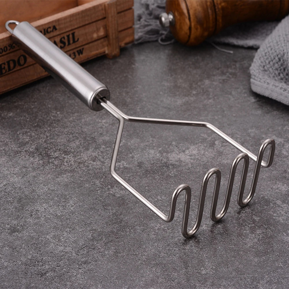 potato masher on a counter