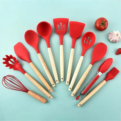 set of red kitchen utensils with wooden handles