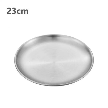 a silver stainless steel round plate with a white background 23 cm