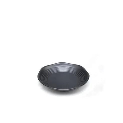 a small black plate on a white background with wavy edges