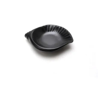 a small black shell shaped plate