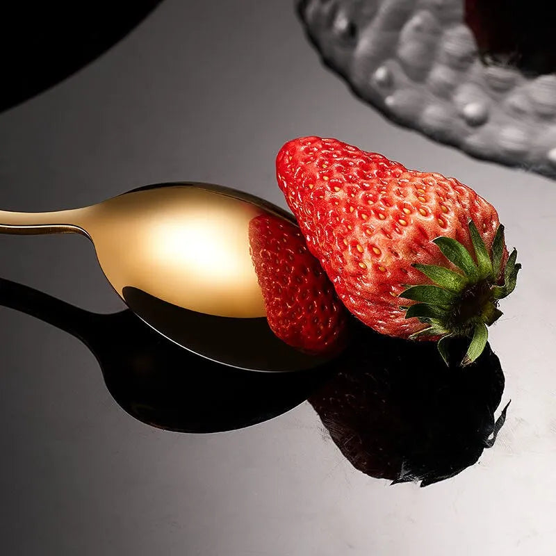 a spoon and a strawberry