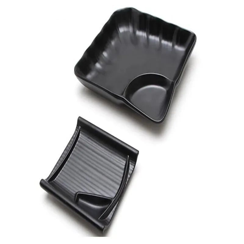 two black sushi trays with a curved edge