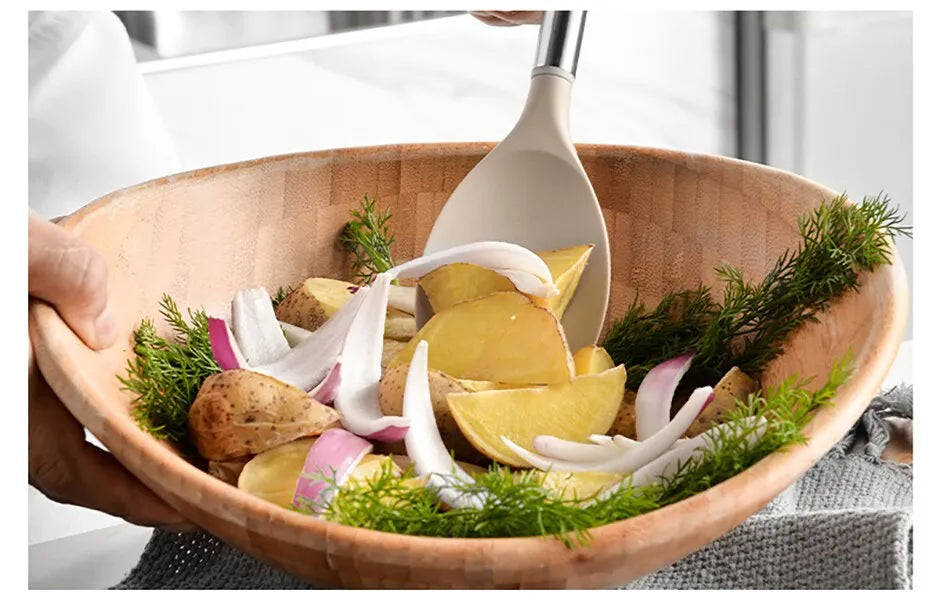 wooden bowl with vegetables and a spoon