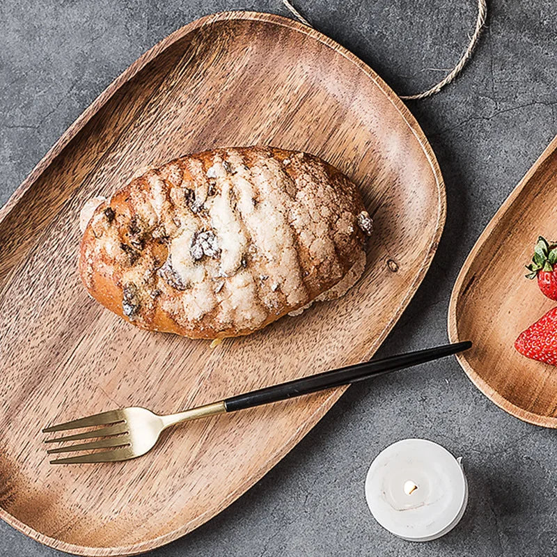 a wooden plate of food and a fork